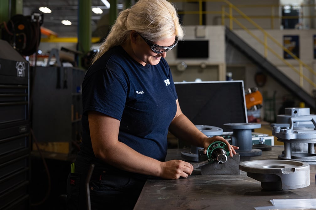 Man working on parts at a table